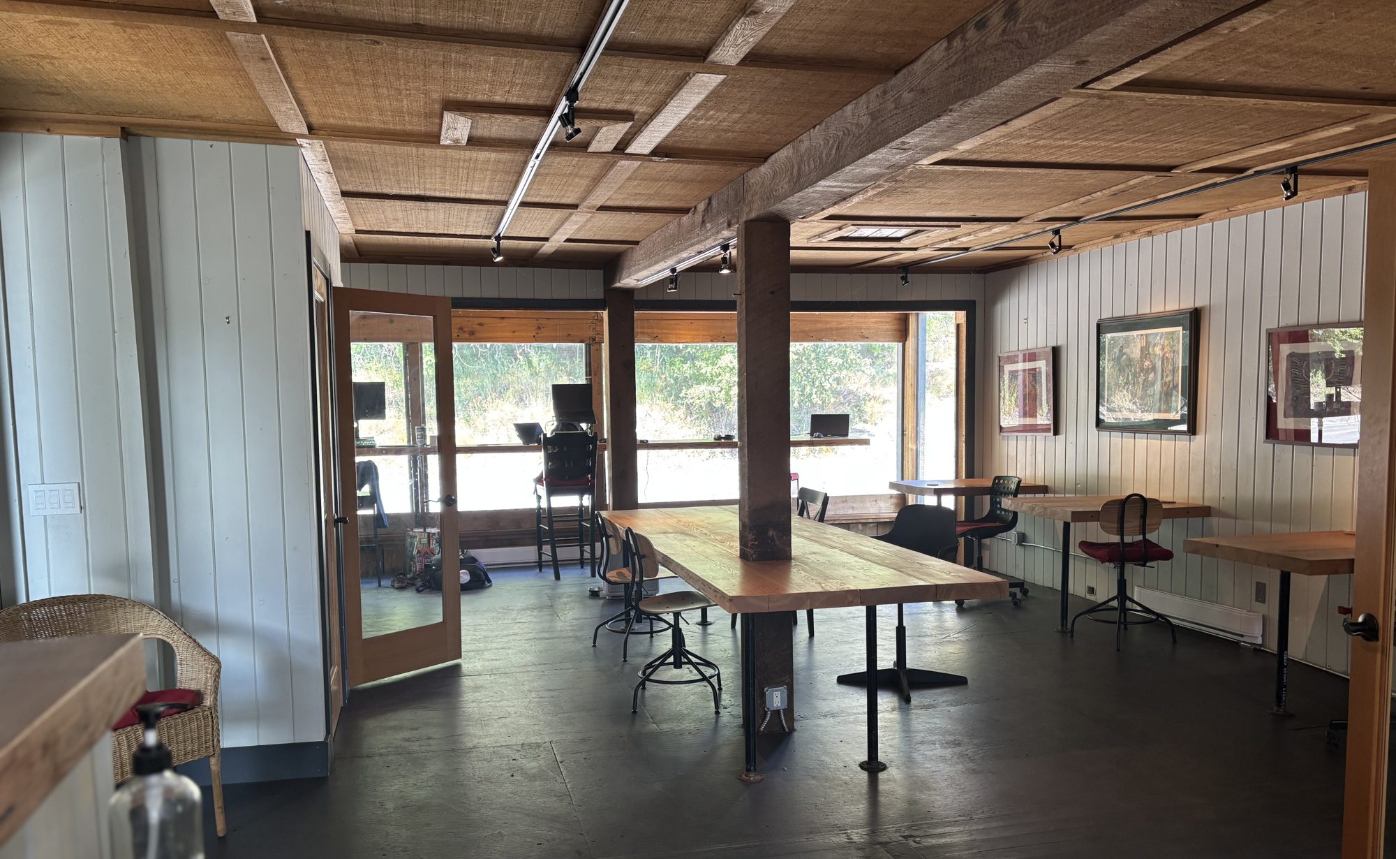 Inside the Drop Zone Cowork space: communal tables, big windows, exposed wood beams